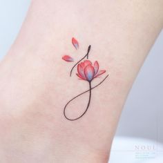 a small tattoo on the ankle of a woman's foot with a red flower