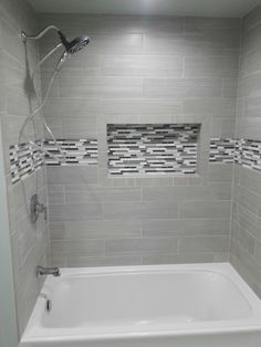 a white bath tub sitting inside of a bathroom next to a shower faucet