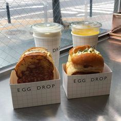 two egg drop sandwiches and a drink on a table