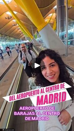 a woman is smiling while riding an escalator