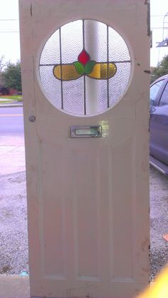 a white door with a stained glass window