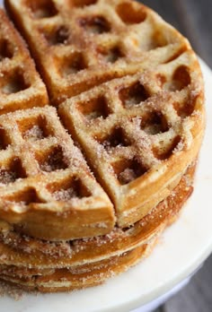 a stack of waffles sitting on top of a white plate