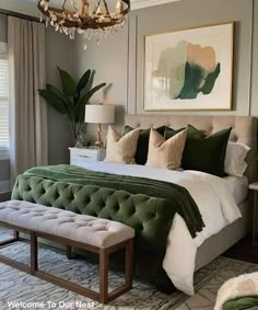 a green and white bedroom with a chandelier