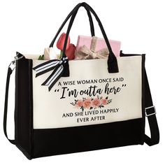 a black and white shopping bag with an embroidered message on the front that says, i am outa here and she lived happily ever after