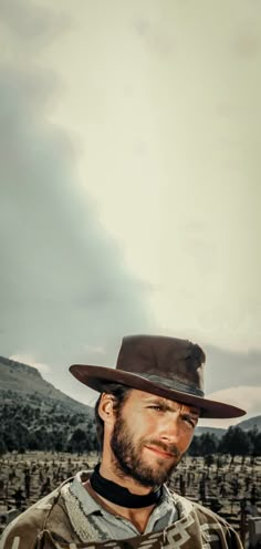 a man wearing a hat and jacket in the desert