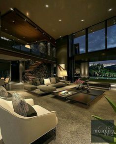 a living room filled with lots of furniture next to large windows and a fire place