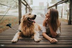 a woman laying on the ground next to a dog