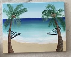 someone is holding up a painting with two palm trees and a hammock on the beach