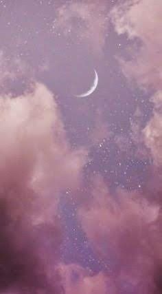 the sky is filled with clouds and a half moon in the distance, as seen from below