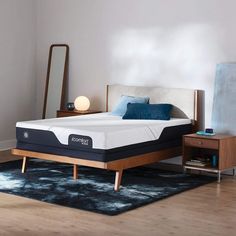 an image of a mattress on a bed frame in the middle of a living room