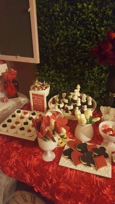 a table topped with lots of desserts and cupcakes on top of it