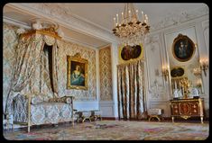 an ornately decorated room with paintings and chandeliers