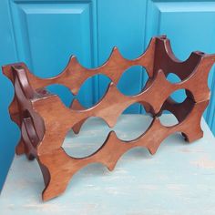 a wooden shelf sitting on top of a blue table