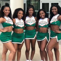 the cheerleaders are posing for a photo together in their green outfits and white sneakers