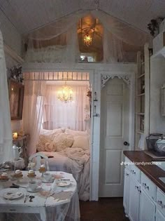 a bedroom with a bed, table and sink in it's centerpieces