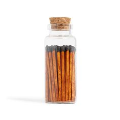 cinnamon sticks in a glass jar on a white background