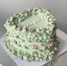 a green cake with pink flowers on it