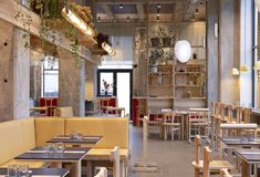 an empty restaurant with wooden tables and chairs