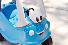 a blue toy car with a smiling face