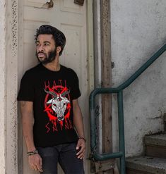 a man standing in front of a door wearing a t - shirt with an animal on it