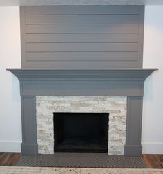 the fireplace is painted gray and white