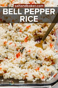 a casserole dish with rice and carrots in it, topped with a serving spoon