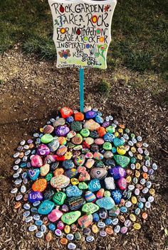 there is a sign that has been placed on the ground with many rocks in it