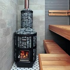 a wood burning stove sitting inside of a bathroom