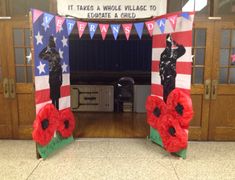 two red poppies in front of an american flag arch