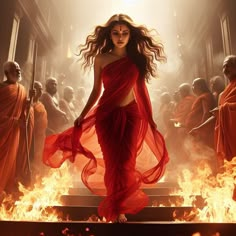 a woman in a red dress is standing on fire with other people behind her and holding torches