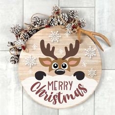 a wooden sign that says merry christmas with a reindeer's head and antlers on it