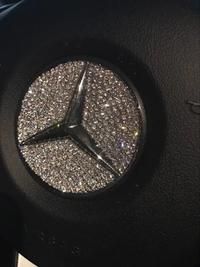 the mercedes logo is shown on the steering wheel and center hubs in this photo