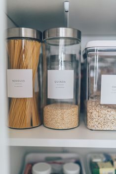 three glass containers filled with food on top of a shelf