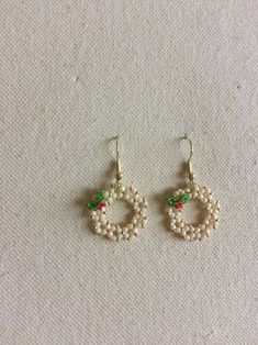 the earrings are made with pearls and green beads