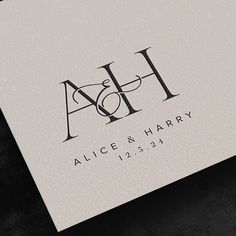 a white business card with the letter h and an elegant monogrammed logo on it