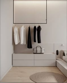 a white room with clothes hanging on the wall