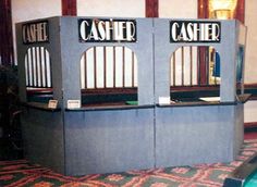 two cash register machines sitting on top of a carpeted floor next to each other