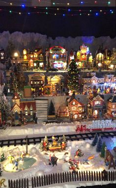 a model train set with christmas decorations and lights