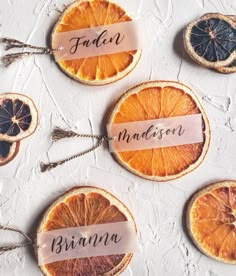 orange slices with name tags on them sitting next to each other in front of a white background