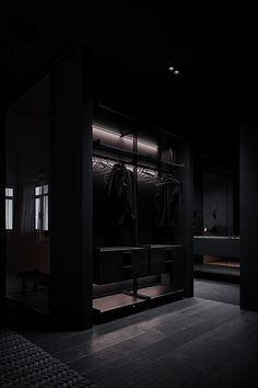 a dark room with some clothes hanging in it