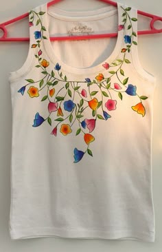 a white tank top with colorful flowers on it