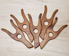 four wooden utensils sitting on top of a table