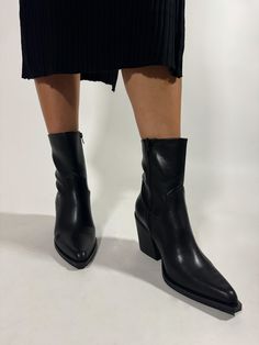 Step into style with our Short Pointed Leather Boot. Crafted from premium faux black leather, these boots feature a sleek design with a striking angular heel. Enjoy all-day comfort with a cushioned insole and flexible sole, making them the perfect blend of fashion and ease. Leather Boot, Dress Romper, Skirt Pants, Dress Pants, Leather Boots, Sleek Design, Athleisure, Black Leather, Rompers