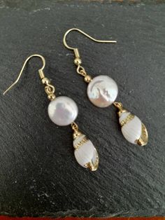 These beautiful earrings are made from real gold plated seashells and Baroque Pearls. The seashells are around 18mm long, Baroque Pearl  12mm, ear-wires are gold filled. Each item is carefully packaged in a beautiful jewellery box ready as a gift. If you would like to add a personalized note with your order, just write a note at checkout and I will send a small card with your gift to the recipient. If you need a bigger quantity or any customized jewellery for your very special occasion (birthdays, weddings, bridal showers or any other event), please send me a message and I'll be glad to help. Gold Teardrop Earrings For The Beach, Shell-shaped Pearl Charm Earrings As Gift, Elegant Pearl Charm Earrings With Shell, Pearl Shell Drop Earrings With Pearl Drop Detail, Elegant Shell Pearl Earrings For Gift, Elegant Pearl Drop Mother Of Pearl Shell, Elegant Mother Of Pearl Shell With Pearl Drop, Gold Shell Dangle Earrings, Elegant Shell Dangle Earrings