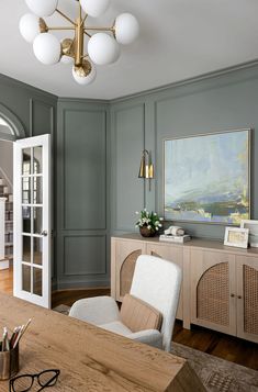 a living room with gray walls and wooden furniture