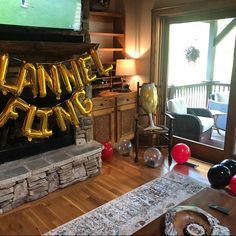 a living room filled with furniture and balloons in the shape of letters that spell happy birthday