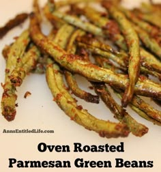 oven roasted parmesan green beans on a white plate with text overlay that reads oven roasted parmesan green beans