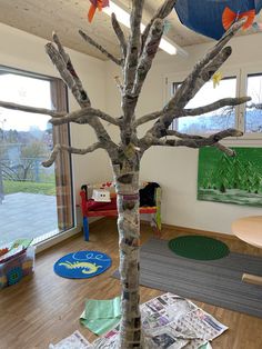 a tree made out of newspaper sitting in a room