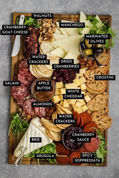 a cheese board with all the different types of cheeses and crackers on it