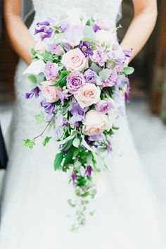 a bride holding a bouquet of flowers in her hands